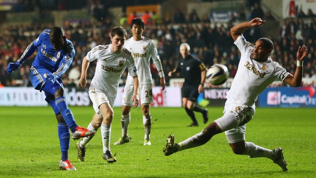 Demba Ba of Chelsea shoots past Ashley Williams
