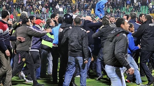 Spectators were crushed when panicked crowds tried to escape from the stadium after a pitch invasion by supporters of Al-Masry