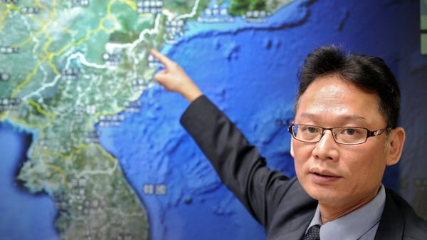 Chen Kuo-chang, a senior technical specialist from Taiwan's Seismology Center points towards a North Korean map at the location that North Korea staged a nuclear test