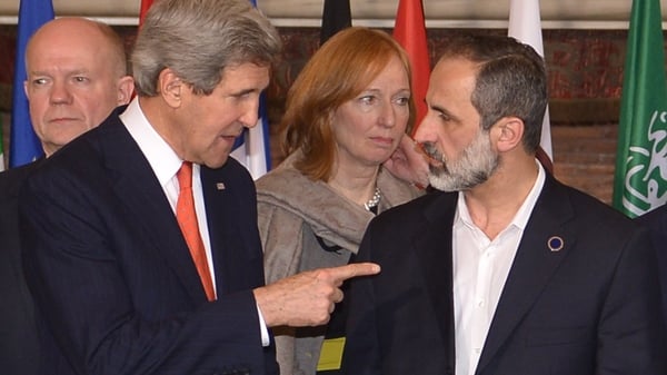 John Kerry (L) speaks to Syrian opposition leader Moaz al-Khatib at the 'Friends of Syria' meeting in Rome