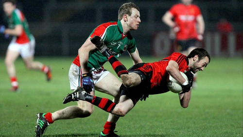 Conor Laverty goes to ground under a challenge from Mayo's Colm Boyle