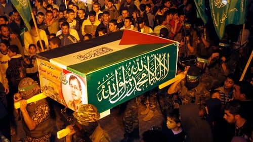 Palestinian Hamas militants hold a symbolic coffin for Maysara Abu Hamdeya during a protest yesterday