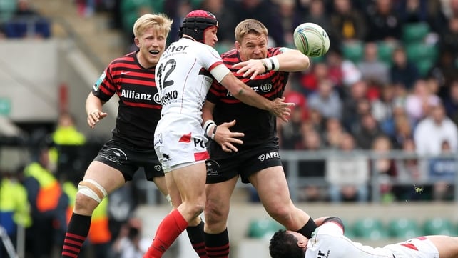 John Smit of Saracens loses the ball as he is tackled by Matt Giteau (left) and Chris Masoe (right) 