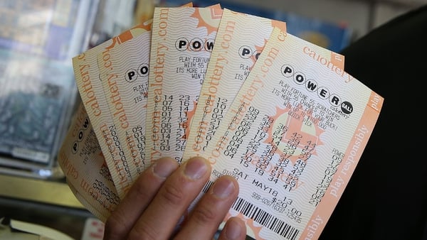 A customer holds $140 worth of Powerball tickets