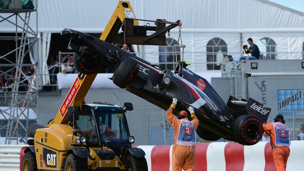 A crane lifts Esteban Gutierrezs' Sauber car at the end of the Canadian Formula One Grand Prix