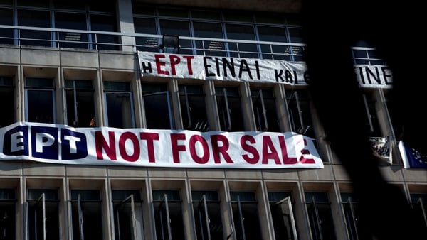 A 'not for sale' banner hangs on the facade of the Greek state television ERT headquarters