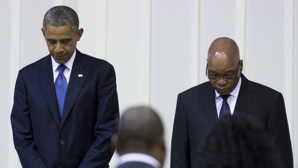 Barack Obama and Jacob Zuma bow their heads during a moment of prayer for Nelson Mandela during an official dinner in Pretoria last night