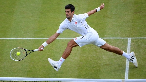 Novak Djokovic reaches for a shot during his match with Tomas Berdych