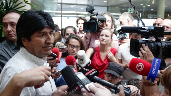 Evo Morales speaks to reporters in the airport in Vienna