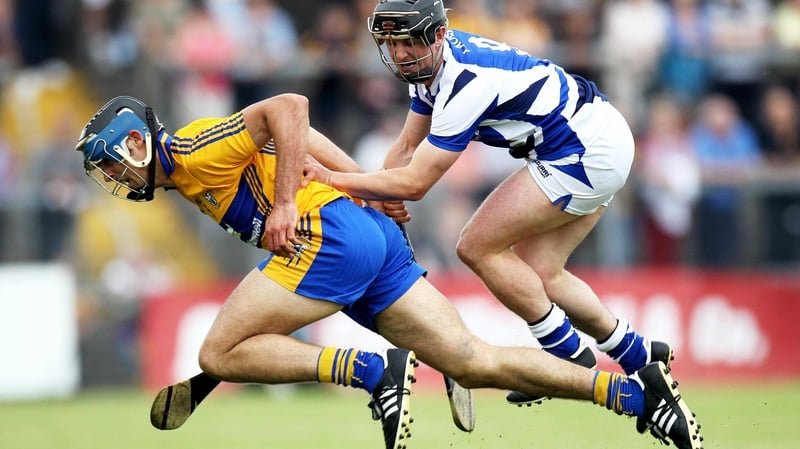 Clare's Brendan Bulger jostles with James Walsh of Laois