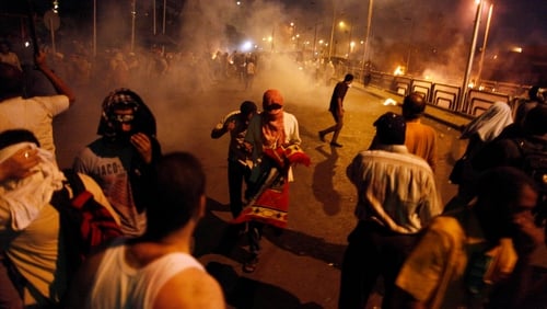 Egyptian supporters of the Muslim Brotherhood clash with police outside the elite Republican Guard base in Cairo