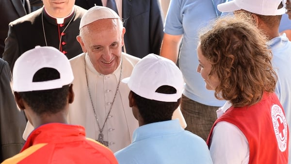 Francis greeted newly arrived migrants and said Mass on the island's sports field