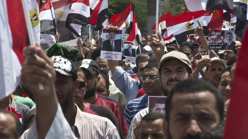 Supporters of Mohammed Mursi marching towards Cairo University yesterday