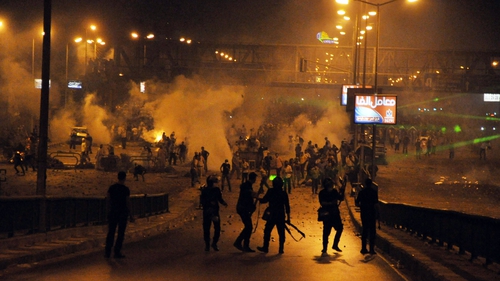 Supporters of Mohammed Mursi clash with riot police in Cairo