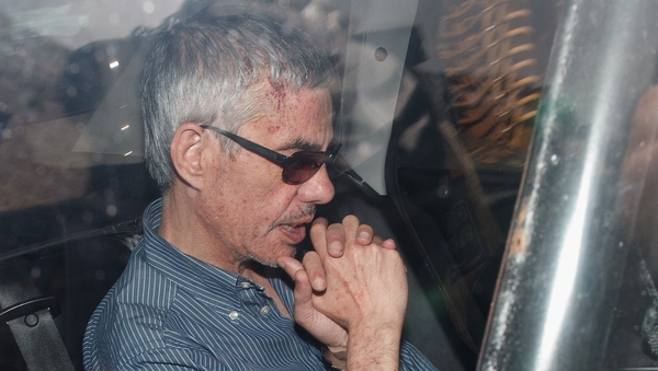 Train driver Francisco Jose Garzon Amo is taken in a police car to the preliminary court last night