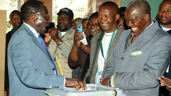 President Robert Mugabe casts his vote