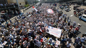 Pro-Mursi supporters carry posters bearing his portrait during a demonstration against the government in Cairo