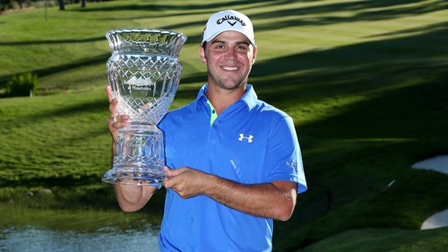 Gary Woodland poses with the trophy after his victory