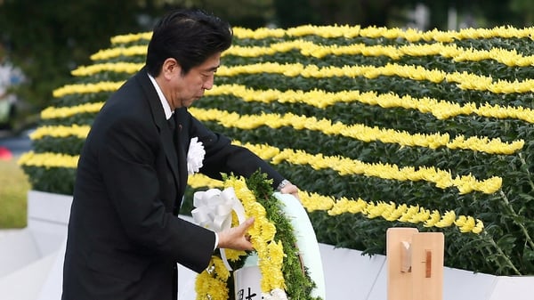 Japanese Prime Minister Shinzo Abe lays a wreath at Hiroshima Peace Park
