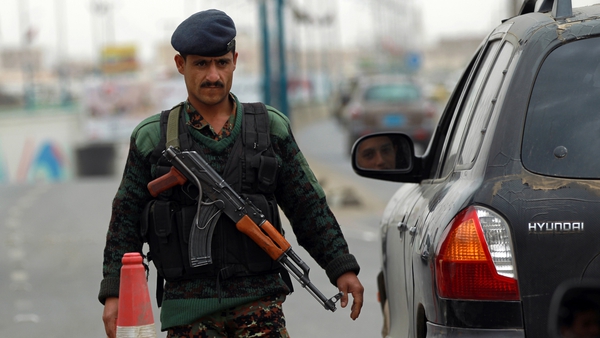 A Yemeni soldier checks vehicles near Sanaa International Airport yesterday