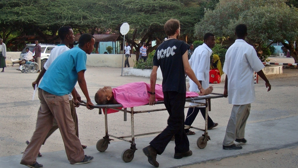Hospital staff and a colleague help a wounded MSF foreign aid worker after a Somali gunman opened fire on an MSF compound