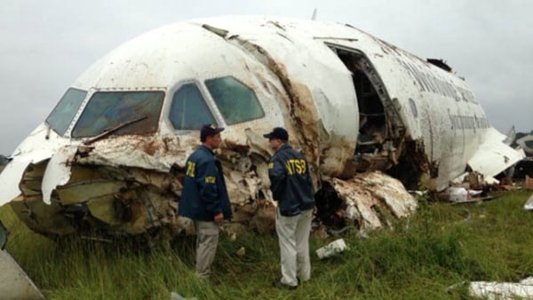 NTSB workers inspect the wreckage of the UPS cargo plane