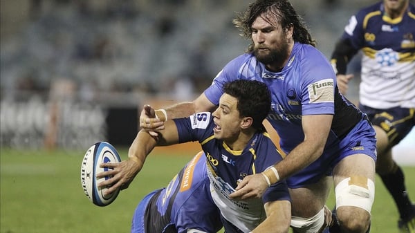 Matt Toomua offloads during a Super Rugby match between the Brumbies and the Force