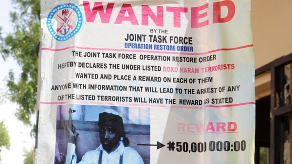 A roadside poster shows photograph of Imam Abubakar Shekau, leader of the militant Islamist group Boko Haram