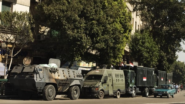 Egyptian riot police vehicles are parked in the main street leading to Cairo's landmark Tahrir square