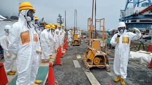 Local government officials and nuclear experts inspect a construction site on 6 August to prevent the seepage of contaminated water into the sea