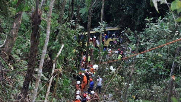 Rescuers take survivors from wreckage of bus crash