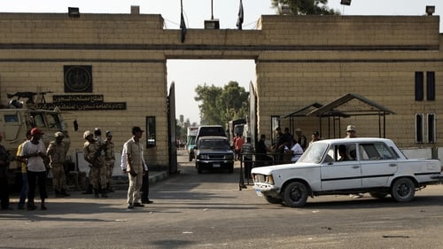 Security guards stand outside the entrance of Cairo's Tora prison