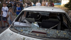 A car was damaged by the remnants of one of the rockets
