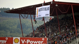 Anti-Shell protestors unfurl a banner at the Belgian Grand Prix