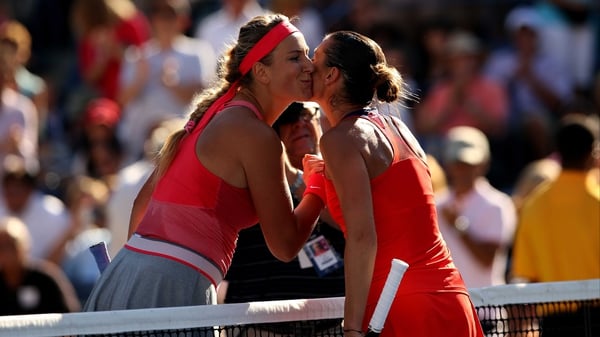 Victoria Azarenka and Flavia Pennetta greet at the net at the end