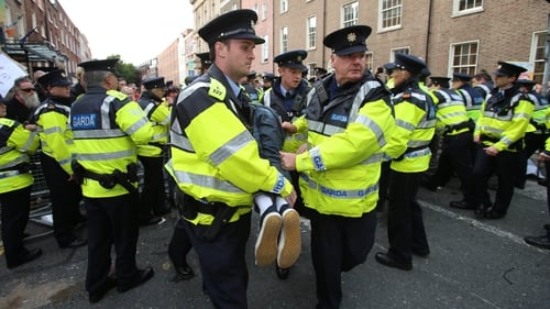 Gardaí restrain a protester outside Leinster House