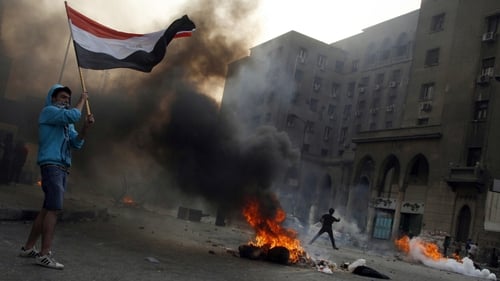 Tyres burn as protesters take part in clashes with riot police in Cairo