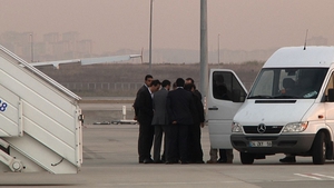 Some of the hostages wait to board a plane after their release