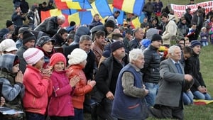Protesters kneel to pray during an anti-fracking protest in Silistea village in Romania