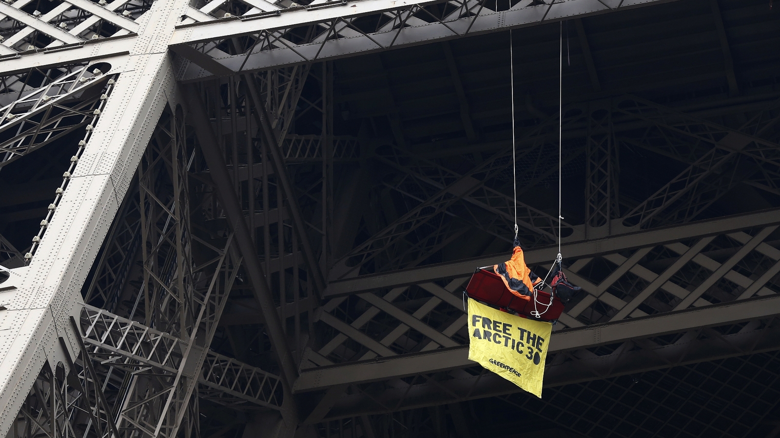 Greenpeace protester swings from Eiffel Tower