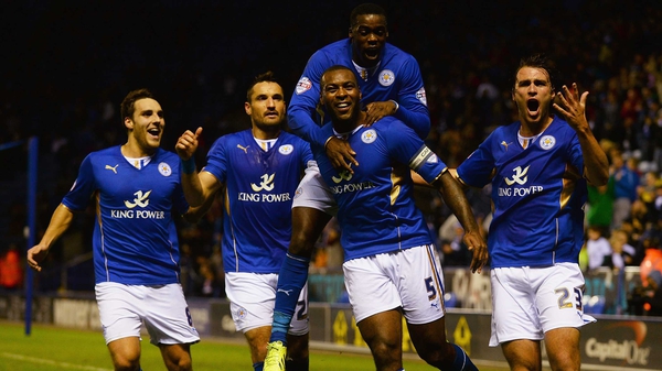 Wes Morgan (centre) of Leicester City is mobbed by team-mates after scoring Leicester's first against Fulham