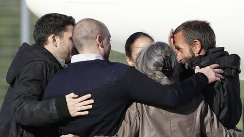 Former French hostage Daniel Larribe (R) is welcomed by his family at Villacoublay