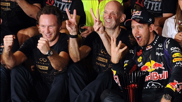 Sebastian Vettel (R) celebrates with technical director Adrian Newey (C) and team prinicipal Christian Horner (L)