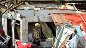A woman surveys the damage caused by Super Typhoon Haiyan