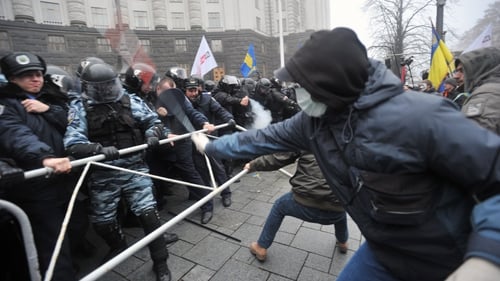 Pro-EU supporters clash with police outside government buildings in Kiev over the scrapped EU deal