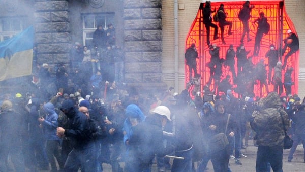 Protesters fired flares at police who threw them back and shot stun grenades into the crowd