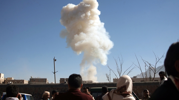 Yemenis look on as smoke rises from the site of a suicide car bombing at the defence ministry in the Yemeni capital Sanaa