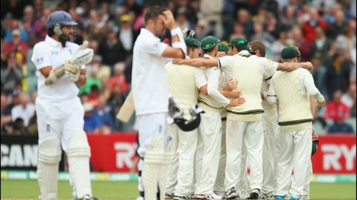 Australia celebrate victory in front of a disconsolate Monty Panesar and James Anderson