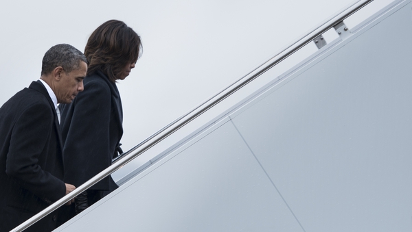 US President Barack Obama and First Lady Michelle Obama board Air Force One to fly to South Africa