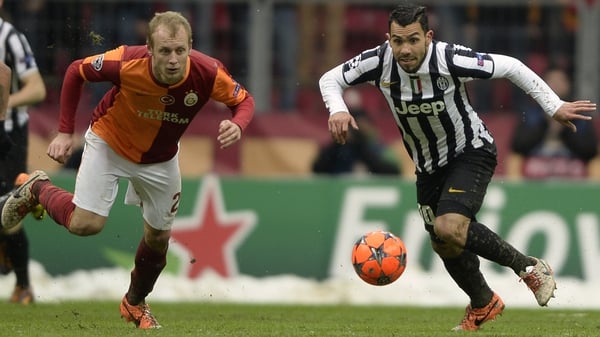 Galatasaray's Semih Kaya (l) with Juventus' Carlos Tevez